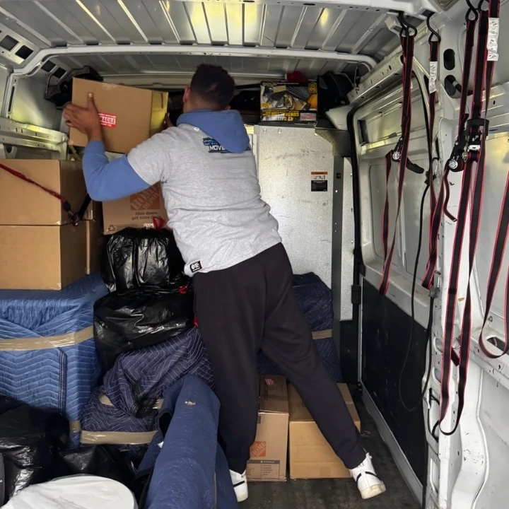 camaj and go mover in white company tshirt packing a truck